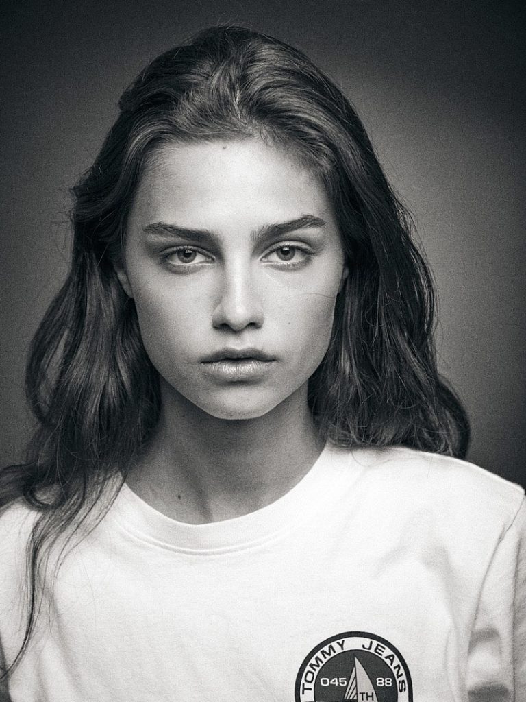 Headshot of Anna Rossolovich with a Tommy Hilfiger T-shirt in my studio