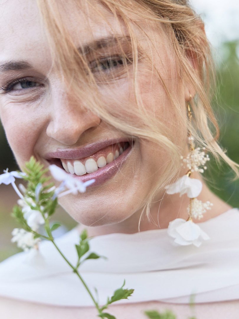 Wedding photographer shooting a close up to a beautiful bride smiling to the camera in Barcelona